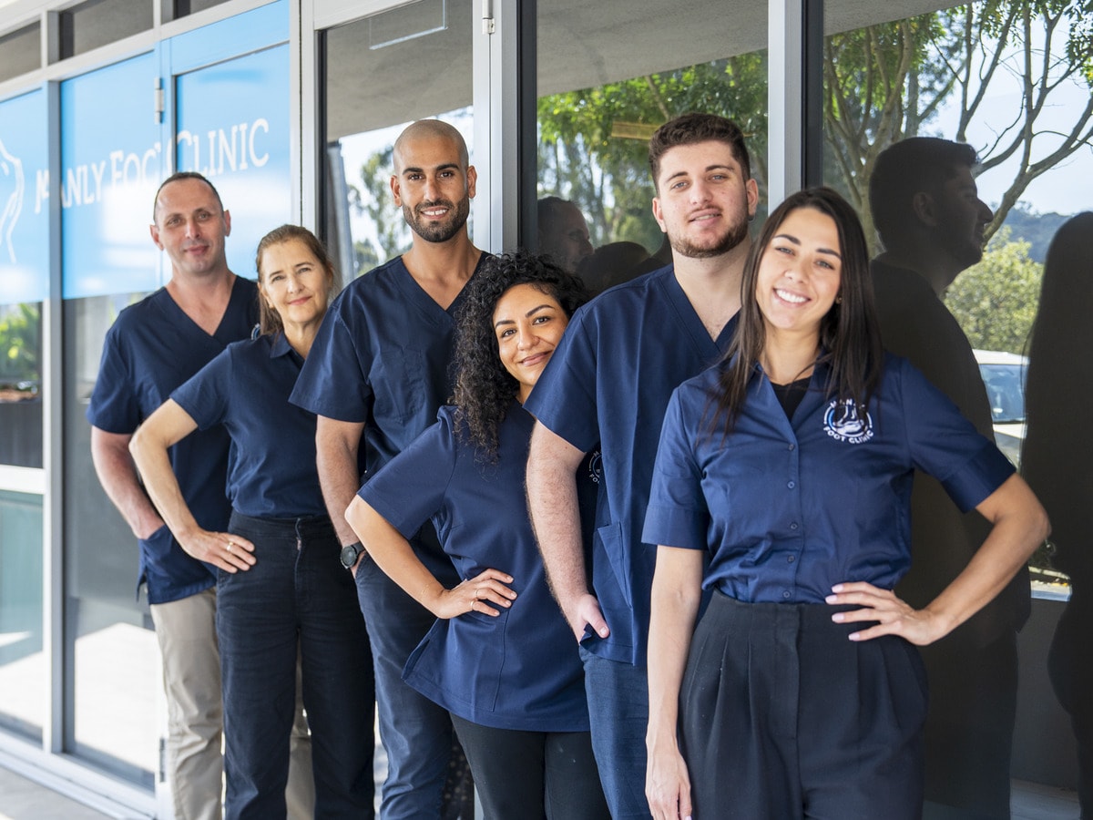 The Manly Foot Clinic team outside the clinic in North Manly, with the clinic sign behind them
